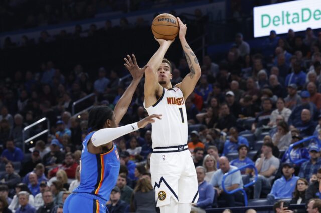 Thunder forward Jalen Williams (8) defends a shot by Denver Nuggets forward Michael Porter Jr. (1) during the second quarter at Paycom Center.