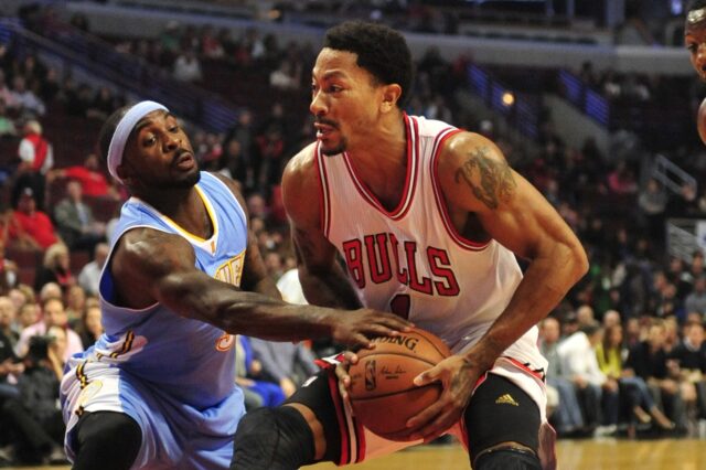 Oct 13, 2014; Chicago, IL, USA; Chicago Bulls guard Derrick Rose (1) is defended by Denver Nuggets guard Ty Lawson (3) during the first quarter at the United Center.